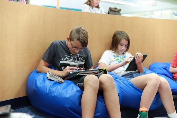 students sitting on bean bag chairs working