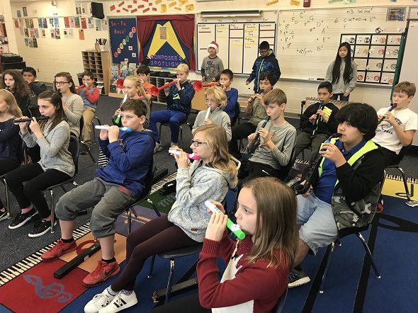 students playing recorders