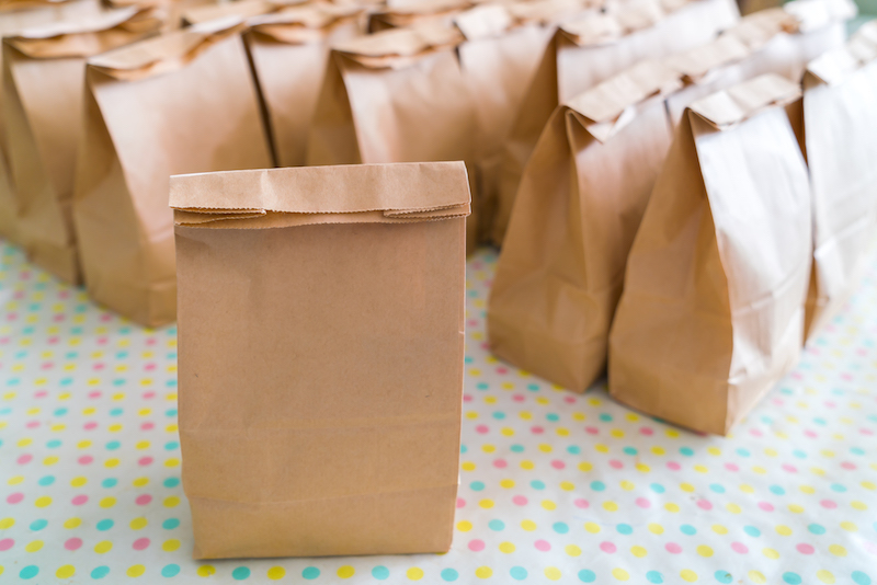 Brown paper bags on table . Brown paper bags on table .