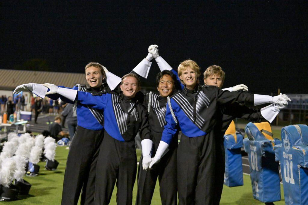 Students enjoying social time at a football game.