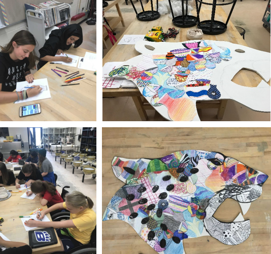 Each member of Jags of Clay decorated an individual paper vessel cutout that was Modge Podged onto the cutout. Each member also made a spot out of clay that was glazed black and attached to the jaguar to make spots.