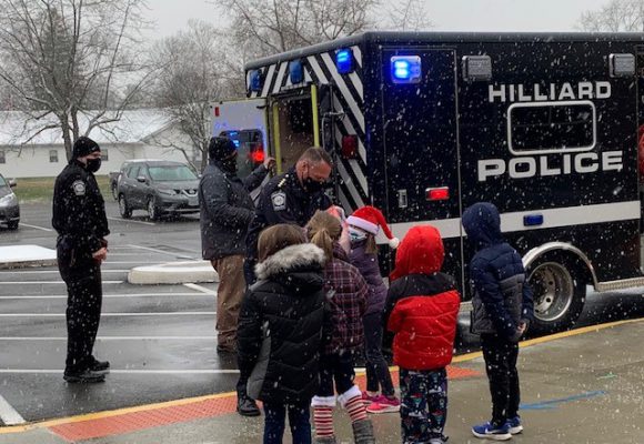 police handing students coats