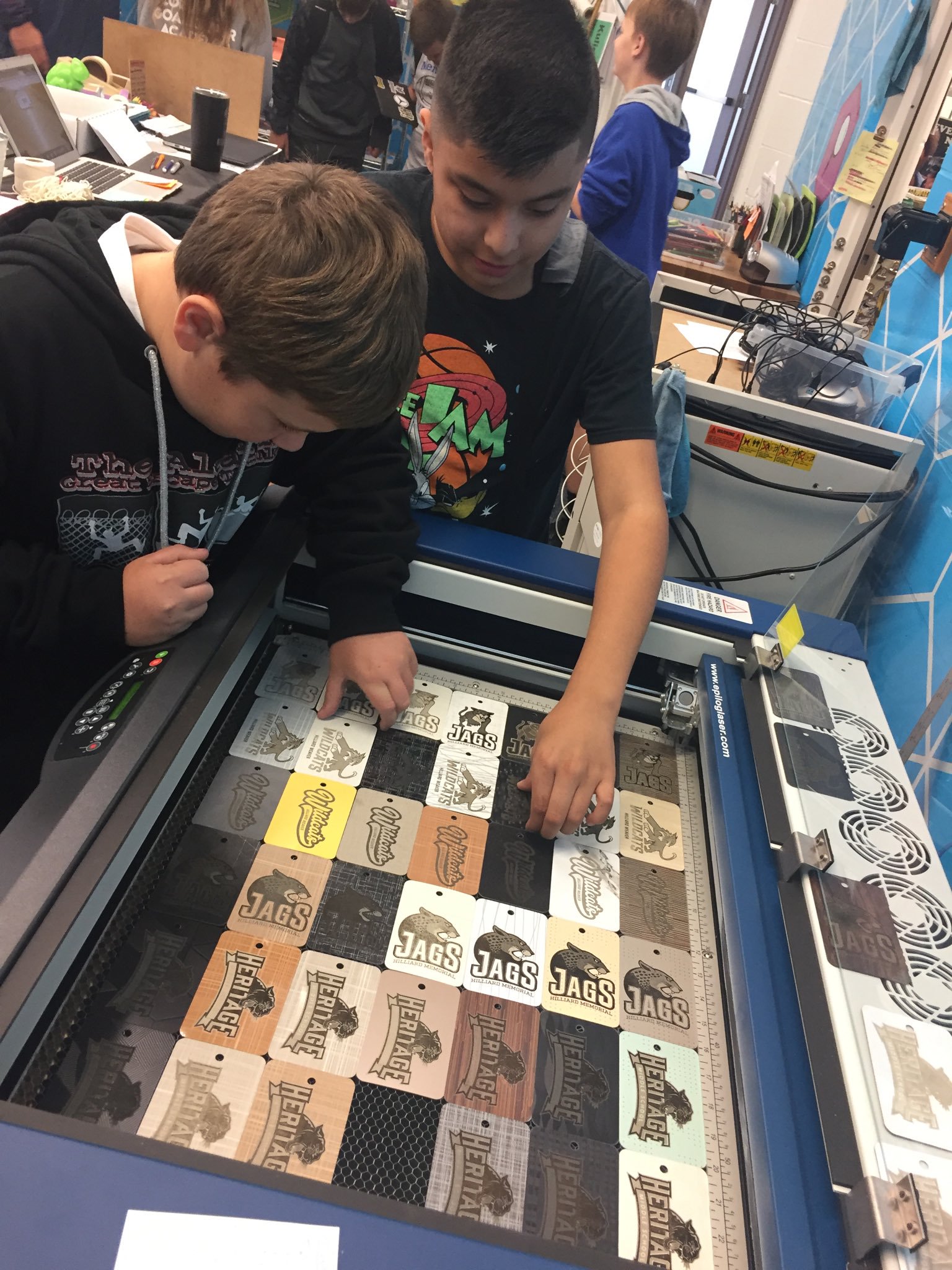 students working on engraving machine