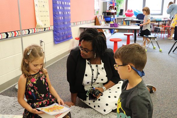 Principal Chatman with two students