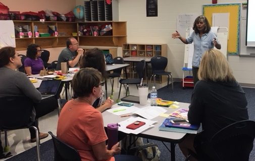teachers in desks learning