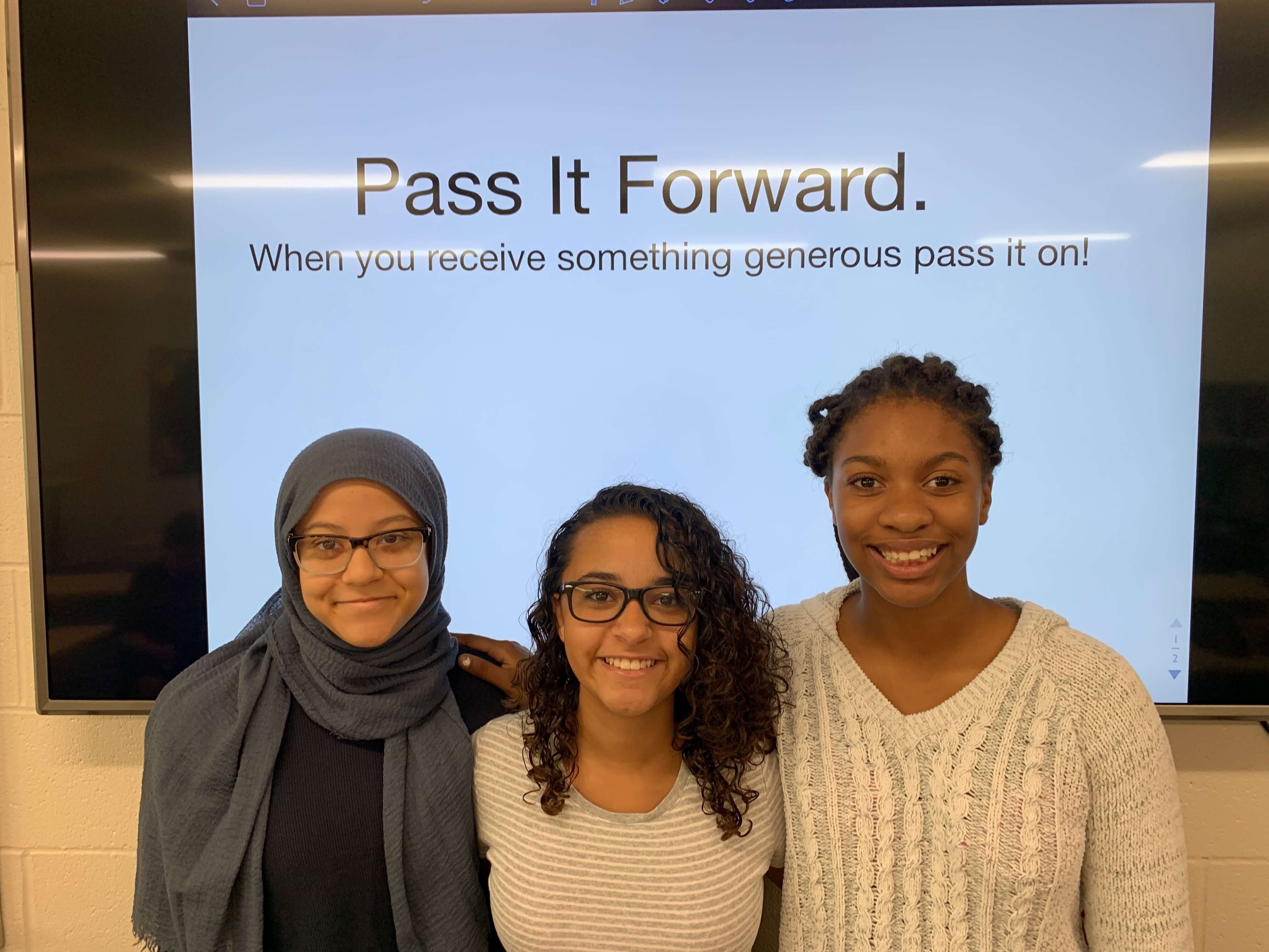 three girls in the class smiling