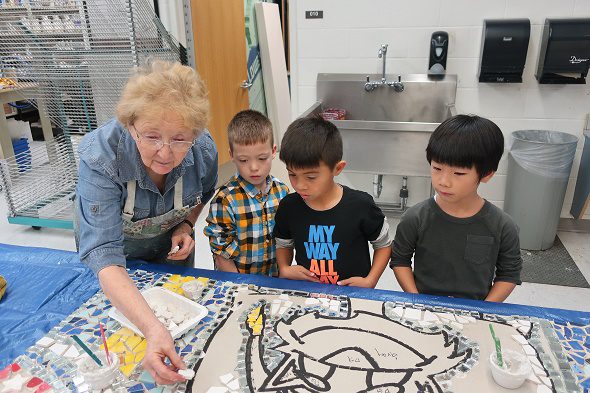 students working with artist