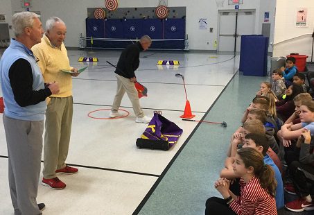 students seeing golf demonstration
