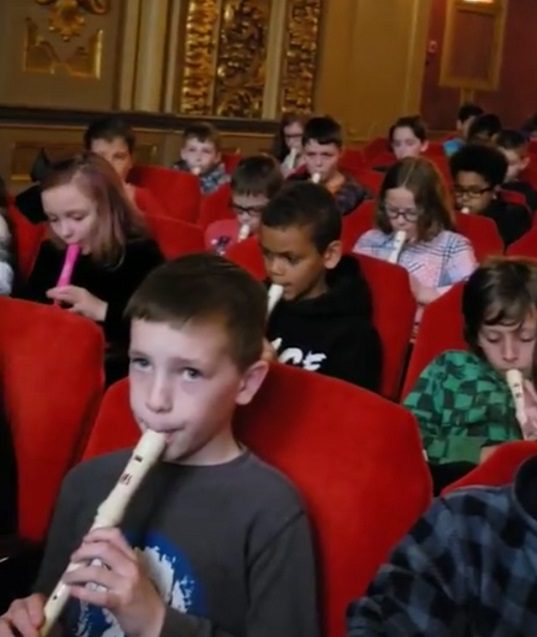 students playing recorders