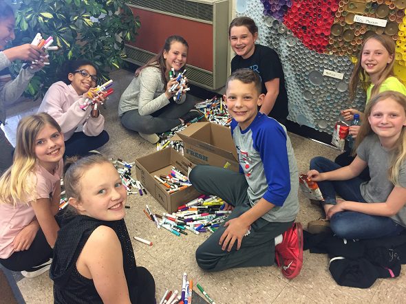 students collecting markers