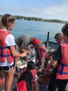 students on a boat checking water quality