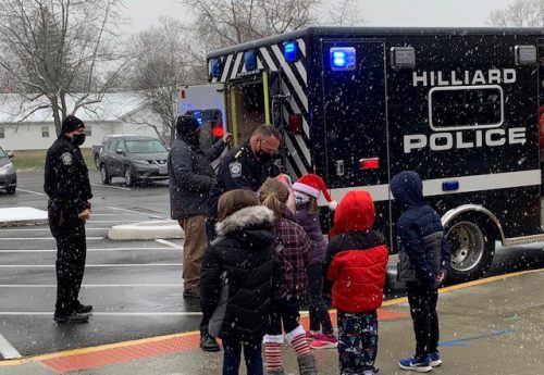 police handing students coats